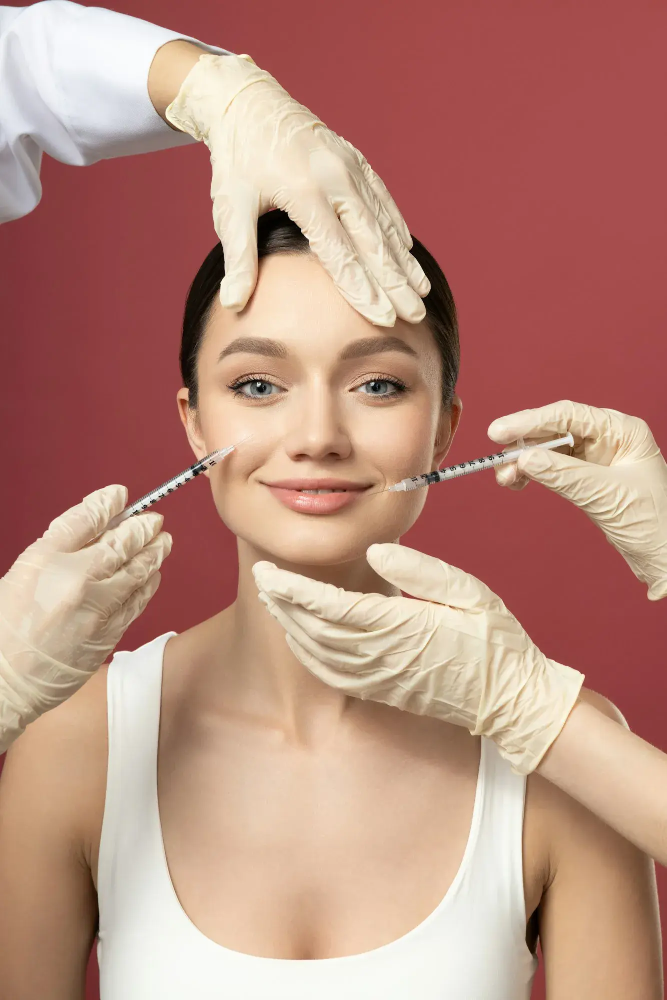 The doctor injects botox to a young girl